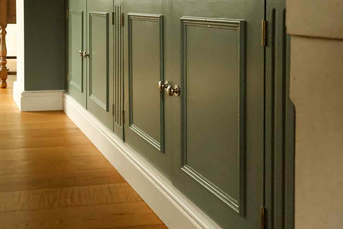 battiscopa bianco sotto una parete verde